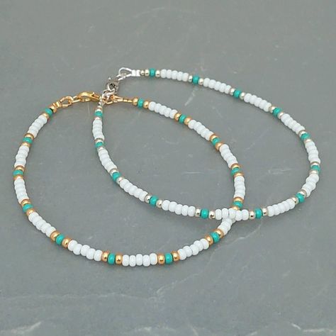 This white turquoise seed bead anklet has been lovingly made using 3mm white and turquoise Preciosa seed beads.  With 3mm Miyuki highlighting beads in either silver or gold. Threaded on strong stainless steel 7 strand Tiger Tail wire and finished with silver/gold plated wire guardians and a lobster clasp, making it easy to put on & take off. With an optional 2" Silver/gold plated extender chain so you can wear the anklet to sit where you feel most comfortable. Matching necklace and or Bracelet a Cute Handmade Bracelets Beads, Cute Necklace Ideas Beads, Cute Beach Necklaces, White And Gold Beaded Bracelet, Anklet Bead Ideas, Diy Seed Bead Bracelet Ideas, Seed Bead Anklet Ideas, Seed Beads Bracelets Ideas, Sea Bead Bracelets Ideas