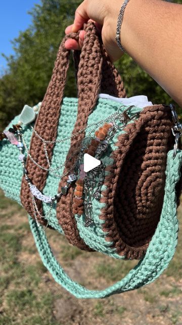 Diamond Alexis on Instagram: "Get into the details 🙂‍↕️🤎

This crochet duffel bag will be for sale (minus a two of the charms).

I’ll be making a few alterations to the side straps as well. I made all of the charms myself and crocheted it myself. So happy with how it came out!

I’ll be selling this one and making myself one in black and white. Probably will make another one. What color combo would y’all want? 👀

#crochet #crochetideas #crochetfashion" How To Crochet A Bag, Crochet Duffle Bag, Crochet A Bag, Crocheting Ideas, Knit Ideas, Crochet Clothing And Accessories, Crochet Clothing, Color Combo, Crochet Fashion