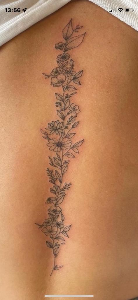 Flower Tattoos Down Spine, Flower Tattoos Back Spine, Spin Flower Tattoos For Women, Colorful Flower Spine Tattoo, Flowers And Vines Spine Tattoo, Back Floral Tattoo Spine, Flower Vine Tattoos Spine, Daisy And Vine Tattoo, Back Tattoo Women Flower Spine