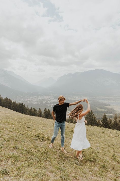 Candid Banff Engagement Photos Summer | Couples Photoshoot Outfits | Cassie Beth Photography | Lauren and Caleb’s adventure engagement photos were filled with playful engagement photos ideas and mountain engagement aesthetic. Find adventure engagement session, mountain top engagement photos, cute hiking engagement and mountain field engagement photos. Book Cassie for your destination elopement in Banff National Park at cassiebethphoto.com! Mountain Top Photoshoot, Couple Pictures In The Mountains, Mountain Top Engagement Photos, Fall Mountain Engagement Photos, Playful Couple Photoshoot, Couples Mountain Photoshoot, Cliff Engagement Photos, Couple Mountain Pictures, Mountain Engagement Photos Outfit