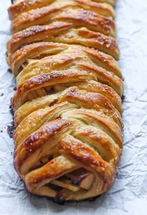 This easy Apple Strudel is filled with cinnamon, brown sugar, raisins and more! It's a crispy, flaky pastry that's easy to make and downright delicious. #applestrudel #applestrudelrecipe #strudelrecipe #strudel #bakedapples #bakedapplesrecipe #appledessert #applerecipe Apple Walnut Strudel Recipe, Apple Streusel Puff Pastry, Granny Smith Apple Puff Pastry, Apple Strudel With Puff Pastry, Apple Puff Pastry Braid, Puff Pastry Apple Strudel, Apple Strudel Pie, Apple Puff Pastry Recipes, Apples And Puff Pastry