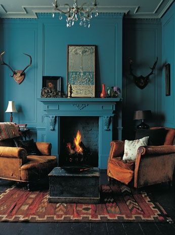 Intense deep teal walls and fireplace with earth brown and red furniture and accessories and antiques plus antlers Teal Living Rooms, Teal Walls, Blue Rooms, Room Redo, Beautiful Living Rooms, Rustic Living, Settee, Wall Color, My New Room