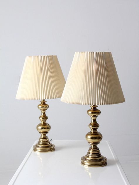 "This is a pair of vintage Stiffel brass table lamps.  The classic baluster style lamps have their original pleated shades.   CONDITION In good, working condition with wear consistent with age and use.  Wiring as found.  MEASUREMENTS Height:  27.75\"  ..  70.5 cm Height to Finial:  27.5\"  ..  69.9 cm Height to Socket:  19.25\"  ..  48.9 cm Base Diameter:  6.5\"  ..  16.5 cm Shade Diameter:  16\"  ..  40.6 cm 423121" Vintage Inspired Interior, Brass Lamp Styling, Vintage Gold Lamp, Vintage Pleated Lamp Shade, Stiffel Lamps Vintage, Gold Vintage Lamp, Stiffel Brass Lamps Vintage, Brass Bedside Lamp, Brass Lamps Vintage