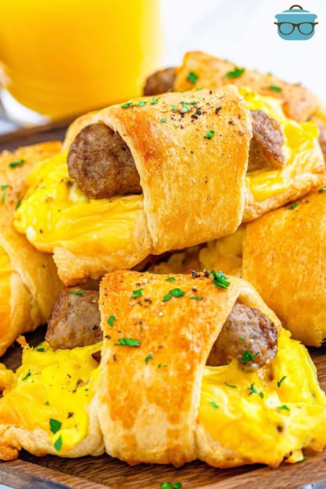 A stack of breakfast crescent rolls shown on a wooden serving plate with a glass of orange juice in the background. Crescent Breakfast, Eggs Cheese Breakfast, Vegetarian Nachos, Breakfast Sausage Links, Egg Benedict, Morning Meals, Teacher Breakfast, Breakfast Slider, Thanksgiving Breakfast