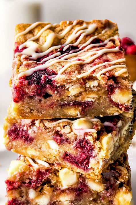 Raspberry White Chocolate Blondies are heavenly. Tangy raspberries and creamy white chocolate, baked into moist, chewy blondie perfection. White Chocolate Raspberry Brownies, Raspberry And White Chocolate Blondies, Raspberry Blondies Recipe, Raspberry White Chocolate Bars, White Chocolate Raspberry Blondies, White Chocolate Raspberry Bars, White Chocolate Raspberry Desserts, Frozen Raspberry Recipes, Raspberry Blondies