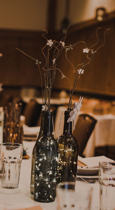 Wine Bottle With Lights Centerpieces, Fairy Lights In Wine Bottles, Wine Bottles With Fairy Lights, Wine Bottle Lights Centerpiece, Fairy Lights Bottle, Lighted Wine Bottle Centerpieces, Fairy Lights In Wine Bottles Wedding, Wine Bottle Fairy Lights Centerpiece, Wine Bottle Candles Wedding