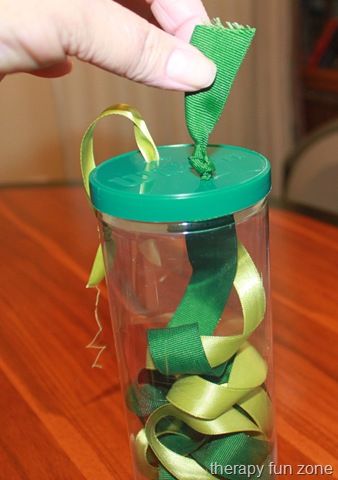 Pulling on small objects is great for working on fine motor skills, and what better small object to pull on than a ribbon. I had some tennis ball containers, and thought that the fact that they are see through would make it even more fun and motivating because you can see the ribbon moving inside the container. Pulling on the ribbon requires strength in the pincer grasp.  To make it, I just sliced holes in the lid, and tied the  {Read More} Daisy Activities, Playgroup Activities, Therapy Fun, Toddlers Activities, Infant Classroom, Infant Room, Fun Zone, Preschool Fine Motor, Sensory Ideas