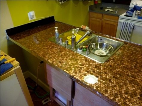 Pennies! If you don’t have the patience for an entire floor, you could always just do your counter. This one’s made of pennies with epoxy poured on top — the epoxy brought the price up to about $7.50 per square foot, still way cheaper than tile — and the maker has put step-by-step instructions up on Makeprojects.com. Penny Countertop, Kitchen Rehab, Penny Floor, Copper Tiles, Diy Countertops, Up House, A Penny, Concrete Countertops, Trendy Kitchen