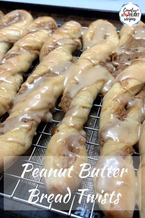 Peanut Butter Bread Twists are delicious for brunch, a snack, or even a dessert. Tender, sweet bread with a peanut butter and honey filling, then drizzled with a peanut butter icing. They're perfect for any peanut butter lovers in your family. #peanutbutterbreadtwists #peanutbuttertwists #peanutbutter #breadtwists #sweetbread #breadsticks #yeastbread #snacks #brunch #honey #countryatheartrecipes https://countryatheartrecipes.com/2024/01/peanut-butter-bread-twists/ Honey Filling, Butter Roll Recipe, Peanut Butter And Honey, Bread Twists, Peanut Butter Icing, Bread Toppings, Peanut Butter Bread, Heart Recipes, Cinnamon Twists