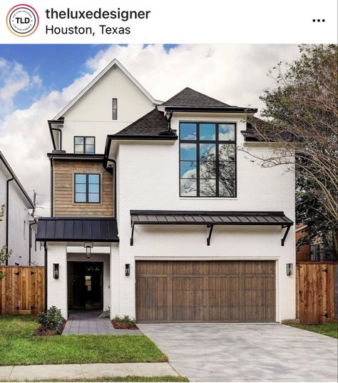 Wood garage door. Metal roof. White brick house. Black roof. Black eaves. White soffit and fascia. Black Fascia White Soffit, White House Wood Garage Door, Black Soffit And Fascia White House, Black Eaves, Black And White Exterior House, Exterior Lanterns, Exterior Railing, Polycarbonate Roof, Wood Garage