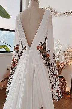 Unique & Non-Traditional Wedding Dresses | Flora & Lane Bohemian Floral Wedding Dress, White Dress Embroidered Flowers, Embroidered Wedding Dress With Sleeves, Flower Embroidered Wedding Veil, Boho Floral Wedding Dress, Wedding Dress With Floral Embroidery, Wedding Dresses With Flowers Detail, Wedding Dress With Flower Embroidery, Boho Fairy Wedding Dress