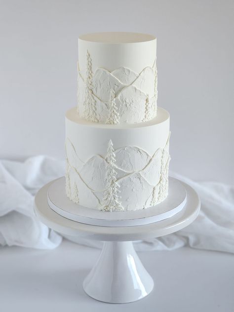 Another buttercream mountain cake. 🤍 - Cakes by Laura Newhouse Two Tier Winter Wedding Cake, White Mountain Cake, Mountains Wedding Cake, Wedding Cake Two Layers, Simple Mountain Wedding Cake, Wedding Cake With Mountains, Buttercream Mountain Cake, Wedding Cake Mountain Theme, Monochromatic Wedding Cake