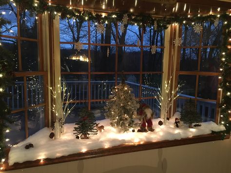 Christmas bay window Christmas Decorating Bay Window, Christmas Village Display Bay Window, Christmas Bay Window Display, Bay Window Christmas Lights, Christmas Decor Window Sill, Bay Window Garland Christmas, Christmas Decorations For Bay Window, Christmas Window Sill, Bay Window Holiday Decor