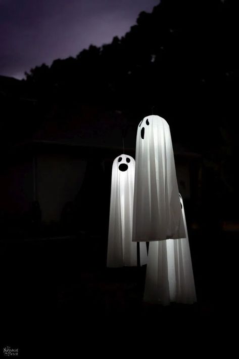 Easy Lighted Hanging Ghosts (A Dollar Store DIY) | DIY lighted hanging yard ghosts - rainproof | Repurposed plastic table cloths | Upcycled Dollar Store paper lanterns | How to make a life size hanging ghost with lights | DIY life-size Halloween prop | #TheNavagePatch #Upcycled #easydiy #DIY #Halloweendecor #DollarStore #HowTo #Halloween #Repurposed #DollarTree #ghost | TheNavagePatch.com Ghost In Tree Decoration, Ghosts Halloween Decorations, Diy Hanging Ghost Outside, Halloween Ghosts Diy Yard Decorations, Fun Halloween Decorations Diy, How To Make Ghosts For Outside, Diy Ghosts Outdoor, Diy Halloween Yard Decorations, Tree Ghosts