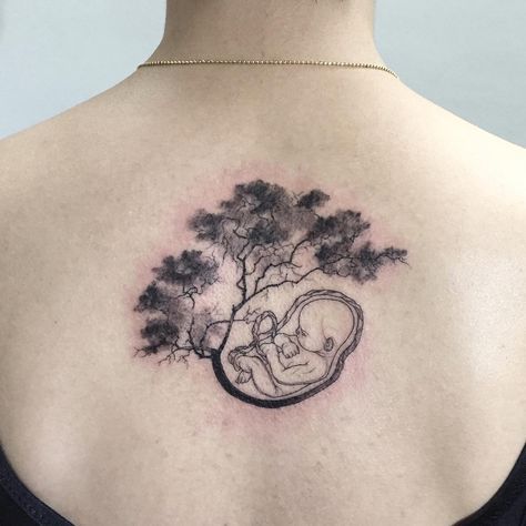 No photo description available. Embryo Tattoo, Mother And Baby Tattoo, Breastfeeding Tattoo, Baby Tattoo, Mommy Tattoos, Mens Shoulder Tattoo, Baby Poster, Badass Tattoos