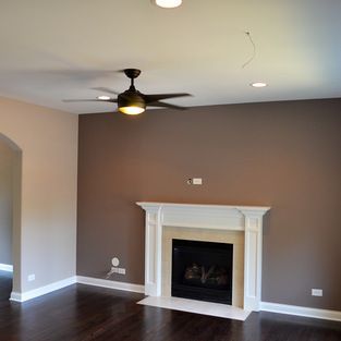 The main color is Sherwin Williams SW6079 Diverse Beige, and the fire place accent wall is Sherwin Williams SW6039 Poised Taupe. Both are in a Flat Finish. The trim is Sherwin Williams Bright White, Semi-Gloss. Diverse Beige, Brown Accent Wall, Poised Taupe, Brown Walls Living Room, Design Ložnic, Paint Walls, Room Colours, Brown Living Room Decor, Traditional Family Room