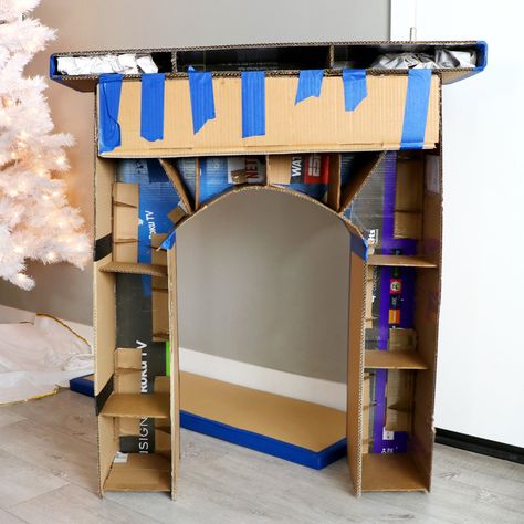 DIY Faux Cardboard Fireplace Christmas Decoration Faux Fireplace Diy Cardboard, Diy Christmas Fireplace, Xmas Fireplace, Diy Paper Christmas Tree, Cardboard Fireplace, Diy Christmas Decorations, Holiday Fireplace, Fake Fireplace, Christmas Booth