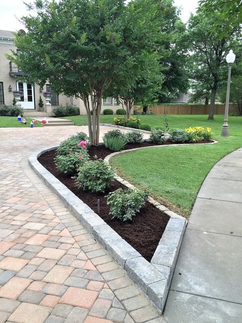 We added this new planting bed along side the paver driveway we installed. Garden Bed Along Driveway, Paver Planters Flower Beds, Driveway With Brick Border, Flower Bed Paver Border, Side Driveway Ideas, Driveway With Paver Border, Driveway With Tree In Middle, End Of Driveway Landscaping, Small Yard Curb Appeal