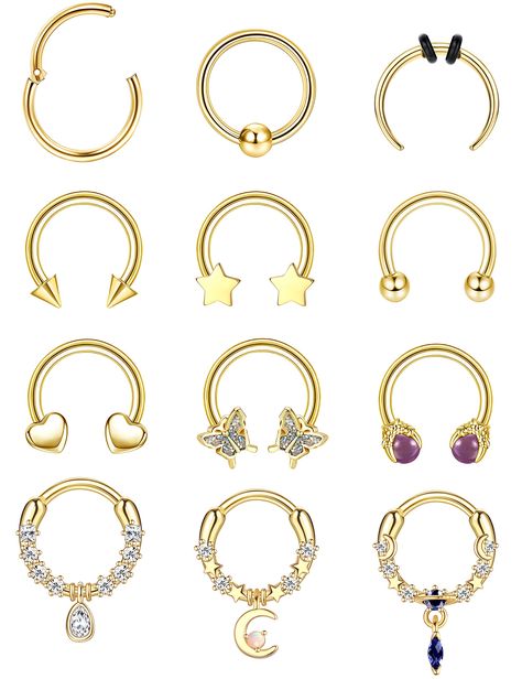 PRICES MAY VARY. Septum Jewelry Set-- You will receive 12pcs septum rings in different styles, including horseshoe septum ring, star septum ring, moon dangle septum ring, heart septum ring, etc. We offer you 3 colors for you to choose, silver, gold and black. Septum Rings Size-- The bar thickness is 16g(1.2mm), the inner diameter is 10mm, suitable for most septum pierce sizes, giving you a great wearing experience. Hypoallergenic Material-- These 16 gauge septum rings are made of high quality su Septum Jewelry Horseshoe, Star Septum, Heart Septum, Gold Septum Piercing, Hoop Septum Piercing, Black Septum, Horseshoe Septum, Gauge Septum, Gold Septum Ring