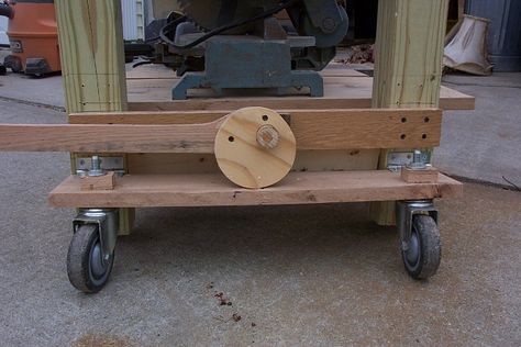 The levers turn a cam that pushes down on the caster board. The whole thing is very simple. The lever lifts the bench extremely easy and there is no noticable flexing, do to stress, on the oak boards. Daryl on woodworkingtalk.com Retractable Wheels, Workbench On Wheels, Retractable Casters, Workbench Casters, Wood Shops, Build Your Own Garage, Workshop Furniture, Tool Carts, Caster Board