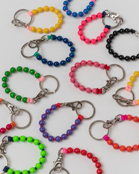 A vibrant and versatile bracelet and keychain. The Perlen Short Keyholder can also be worn as an accessory on your belt loop! Made with sustainable wooden beads and cord thread. Features: Metal clasp. 10 mm wooden beads. Length: 9" Made in Germany About Ina Seifart German design label, Ina Seifart brings creative accessories with a twist to our local Santa Barbara boutique. Each collection is based on 'objets trouvÃ©sâ€™, which are vintage pieces that hold aesthetic value. These vintage material Beads Keychain Design, Ina Seifart, Beaced Key Chain, Diy Wood Bead Bracelet Keychain, Beads Belt, Beaded Key Ring Bracelet, Wood Bead Key Chains, Wooden Bead Keyring, Carabiner Keychain Aesthetic