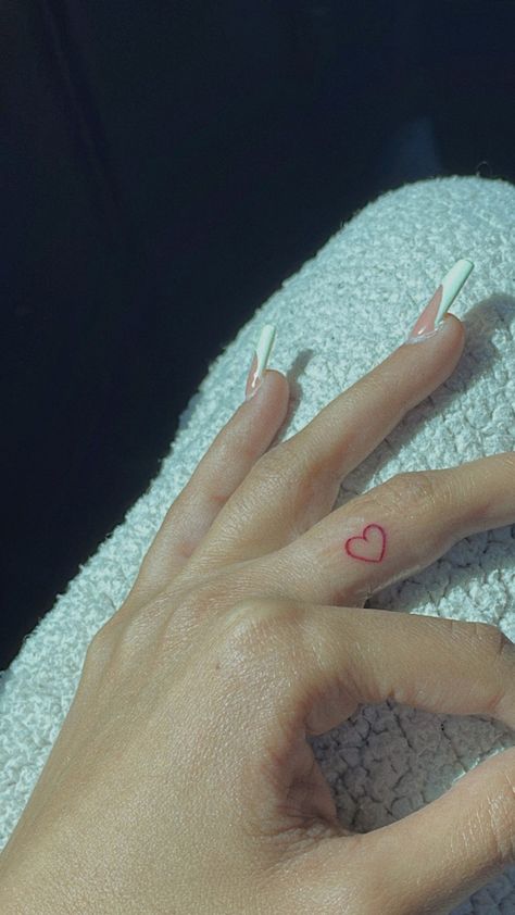 Micro Red Heart Tattoo, Red Heart Hand Tattoo, Fine Line Red Heart Tattoo, Red Ink Tattoos Fine Line, Micro Heart Tattoo Finger, Heart Shaped Tattoo Ideas, Red Ink Finger Tattoo, Red Heart Finger Tattoo, Fine Line Red Tattoo