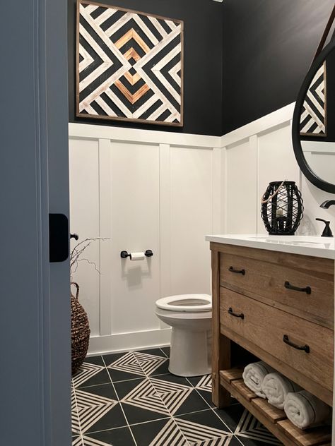 I must say this bathroom turned out amazing! I used a board and batten painted with Pure White by Sherwin Wiliams. The black color on the walls are Tricorn Black by Sherwin-Williams. This color combination paired with the black and white geometric tiles turned out to be stunning. Shop for tile by clicking the photo. Black Wainscoting Bathroom Wallpaper, Black Board And Batten Bathroom, Bathroom Wainscoting Ideas, Shower Redo, Bathroom Wainscoting, Bathroom Downstairs, Bathroom 2024, Black Painted Walls, Chevron Bathroom