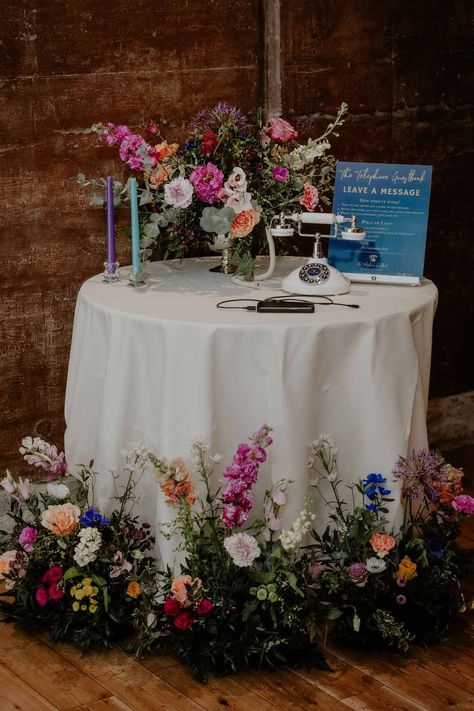 Round table with spring flower arrangements and rotary phone wedding guestbook with purple and teal tapered candles at Elmore Court Gloucestershire Audio Guest Book Table Decor, Guestbooks Ideas For Wedding Table, Audio Guest Book Table, Audio Guest Book Wedding, Wedding Card Table, Guest Book Ideas For Wedding, Orange And White Wedding, Flower Decorations Wedding, Guest Book Table Decor