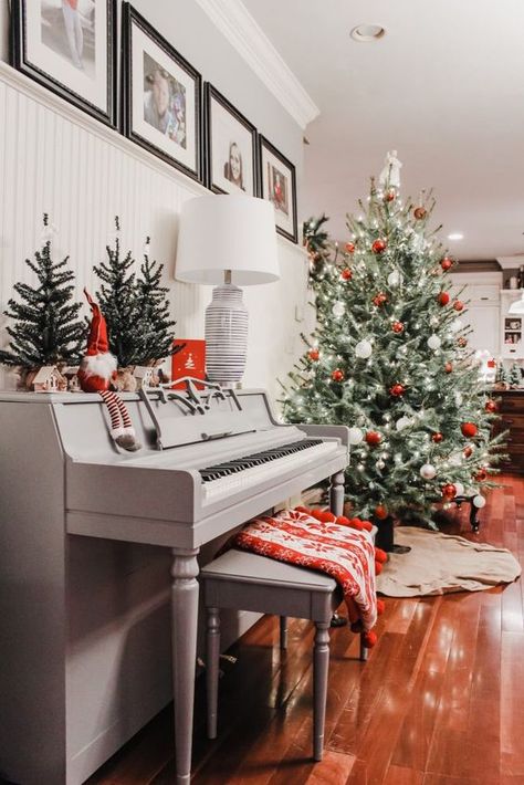 a vintage grey piano with some Christmas trees, a gnome, a grey bench with a printed red blanket, a Christmas tree with red and white ornaments Grey Christmas Decor, Family Room Pillows, Painted Pianos, Piano Decor, Christmas Piano, Exterior Furniture, Grey Christmas, Upright Piano, Christmas Interiors