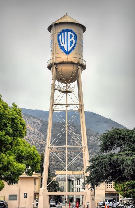 The Warner Bros. Water Tower is a historic water tower located at the Warner Bros. lot in Burbank. Built in 1927, it stands 133 feet tall. The tank has a capacity of 100,000 gallons but it now serves as a company icon. Warner Brothers Logo, Animaniacs Characters, Galaxy Planets, Warner Bros Studios, Movie Studios, Hollywood Studio, Los Angeles Travel, 2025 Vision, Warner Brothers