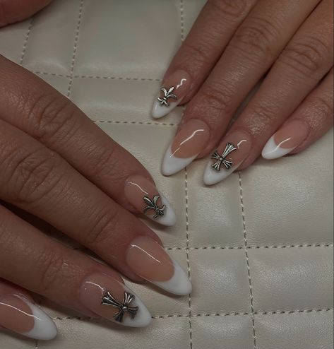 french nails, white nails, clean nails, cute nails, baddie nails, chrome heart decals, silver accent nails, almond nails, almond deep french, deep v cut french, gelx inspo, nail inspo, trendy nails, kylie nails, fall nails, beige nails, nail aesthetic Almond Nails With Cross Charm, Nail Inspo For Paris, Almond Chrome Heart Nails, Almond Nails With Cross, Chrome Hearts Nails Almond, Almond Nails With Charms, Chrome Heart Nails, Chrome Hearts Nails, White Almond Nails