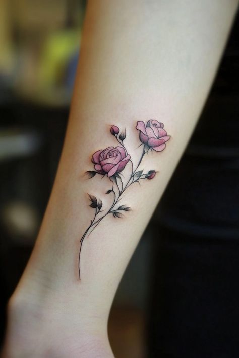 Minimalist tattoo of two pink roses with green leaves on a forearm. Rose Side Wrist Tattoo, Rose With Bee Tattoo, Rose On Forearm Tattoo, Small Unique Tattoos Women, Tea Rose Tattoo, Rose Bird Tattoo, Small Roses Tattoo, 3 Roses Tattoo Design, Rose Snake Tattoo