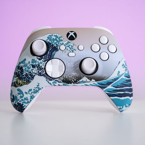 About The design on this Xbox controller is a Japanese piece named “The Great Wave off Kanagawa”. You may have seen it before but didn’t know it’s name ;) Since it’s creation, almost two hundred years ago, it has been interpreted in so many different ways. FOR US, that’s precisely the beauty of having it on the quintessential controller:Customizing your controllers is about self expression and interpretation of what your gaming experience is for YOU. Seeing “The Great Wave” on a Sony controller Custom Game Controller, Xbox Controller Painting Ideas, Custom Xbox Controller, Custom Xbox One Controller, Control Xbox, Custom Controller, Custom Xbox, Dark Vibes, Xbox Wireless Controller