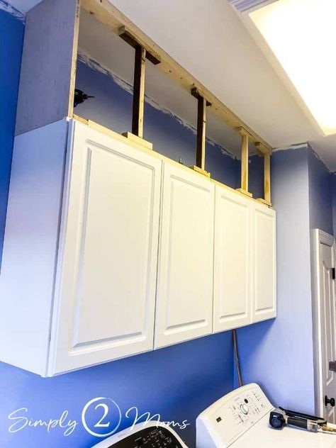 Tired of the ugly, dust-collecting space above cabinets? Learn how to easily extend your cabinets to the ceiling with wood and molding. Get step by step instructions to close up the gap over your cabinets in your kitchen or laundry room. Give your builder grade cabinets a custom look with this simple DIY project! Extending Cupboards To Ceiling, Adding Boxes To Top Of Cabinets, Box On Top Of Cabinets, Upper Cabinets To Ceiling Diy, Raise Kitchen Cabinets To Ceiling Add Shelf, Diy Top Cabinets Build, Above Cabinet Shelving, Diy Extended Kitchen Cabinets, Adding Boxes Above Kitchen Cabinets