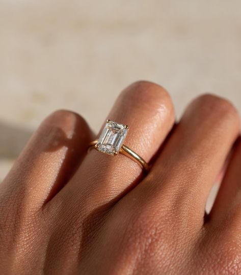 A timeless emerald cut solitaire design, with a lifted cathedral setting ✨ Details: - 2.05ct emerald cut diamond - 18k yellow gold - 1.8mm wide shank #engagementringdesign #customengagementring #emeraldengagementring #nz #aus Emerald Cut Solitaire, Cathedral Setting, Emerald Cut Diamond, Emerald Engagement Ring, Emerald Cut Diamonds, Designer Engagement Rings, Custom Engagement Ring, Emerald Ring, Emerald Cut