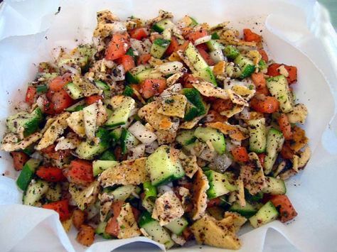 My fav salad! Fatoush is a traditional Lebanese salad made with ripe tomatoes, cucumbers, romaine lettuce, onions, green onions, mint, parsley, fresh squeezed lemon juice, well mashed garlic, extra virgin olive oil, thinly sliced radish, bell peppers and the most important additions that make this salad Fatoush...sumac and toasted pita bread. Lebanon Food, Lebanese Salad, Kurdish Food, Pan Pita, Squeezed Lemon, Tzatziki Sauce, Lebanese Recipes, Ripe Tomatoes, Pita Bread