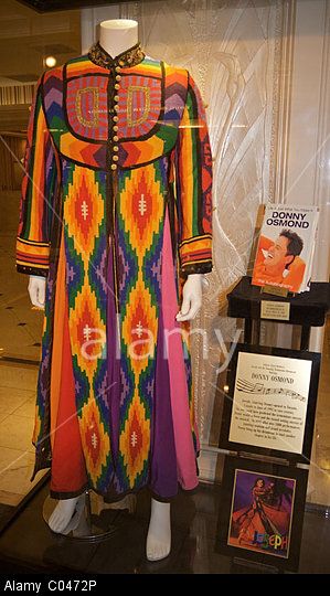 The title garment worn by Donny Osmond in Andrew Lloyd Webber's "Joseph and the Amazing Technicolor Dreamcoat." Stock Photo Joseph's Technicolour Dreamcoat, Joseph Technicolor Dreamcoat, Joseph And The Technicolor Dreamcoat, Joseph And The Amazing Technicolor Coat Costumes, Joseph And The Amazing Technicolor Coat, Joseph Costume, Joseph Coat, Musical Theatre Costumes, Joseph's Coat