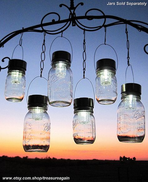 Mason Jar Solar Light: Remove the solar top and light from the post and clear plastic of a small solar light fixture. Screw the solar top and light to the mason jar. Wrap a piece of wire around the lip of the jar to hang it from a hook. Power Nails, Mason Jar Solar Lights, Outdoor Event Lighting, Solar Light Crafts, Solar Mason Jars, Jar Chandelier, Mason Jar Chandelier, Hanging Mason Jars, Jar Lanterns