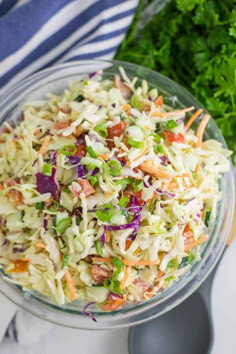 This Summer Slaw takes our family favorite southern coleslaw recipe and adds fresh summer vegetables, including cherry tomatoes, cucumbers, and green onions, and tosses it in a creamy, tangy dressing. Easy to make and a perfect summer side! Summer Slaw Recipe, Southern Coleslaw Recipe, Southern Coleslaw, Summer Slaw, Pea Salad Recipes, Southern Potato Salad, Coleslaw Recipe Easy, Coleslaw Salad, Homemade Coleslaw