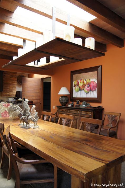 I love the warm wall color and roosters . comedor mexicano / Mexican dining room | Casa Haus Patio Mexicano, Mexican Dining Room, Mexico Interior Design, Orange Dining Room, Mexican Interior Design, Mexican Interiors, Overhead Light, Mexican Home Decor, Ranch Decor