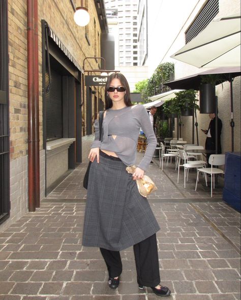 winter outfit, skirt over pants, winter layering inspo, asymmetrical knit, grey outfit, pleated skirt, sporty heels, style inspo, outfit ideas, european style, subversive basics, fashion trends 2023 Skirt Layered Over Pants, Grey Pleated Pants Outfit, 2024 Skirt Trends, Layering Skirts Over Pants, Subversive Basics Fashion, Pleated Skirt Winter Outfit, Grey Pleated Skirt Outfit, Sporty Heels, Pleaded Skirt Outfits