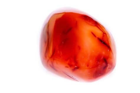 What is Carnelian? Carnelian is a member of the Chalcedony family. It is a silica mineral that takes its color from iron oxide. Carnelian has a hexagonal crystal system and has a vitreous luster. It comes in colors that are reddish brown. The meaning of Carnelian is energy and creativity.   The History of Carnelian The Sunset Stone of Carnelian was named so by the Ancient Egyptians who marveled at the collection of fiery hues simmering in shades of burnt orange and pale pink. Just like a kille Carnelian Meaning, Crystals For Travel, Virgo Birthstone, Root Chakra Stones, Crystal Guide, Crystal System, Carnelian Crystal, Ancient Egyptians, Carnelian Stone