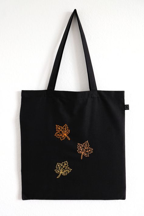 Black tote bag made from high quality organic cotton with hand-embroidered maple leaves Black Tote Bag Embroidery, Toat Bag, Knots Embroidery, Tote Bag Embroidery, Frog Bag, Tot Bag, Bag Embroidery, Embroidered Tote Bag, Embroidered Tote