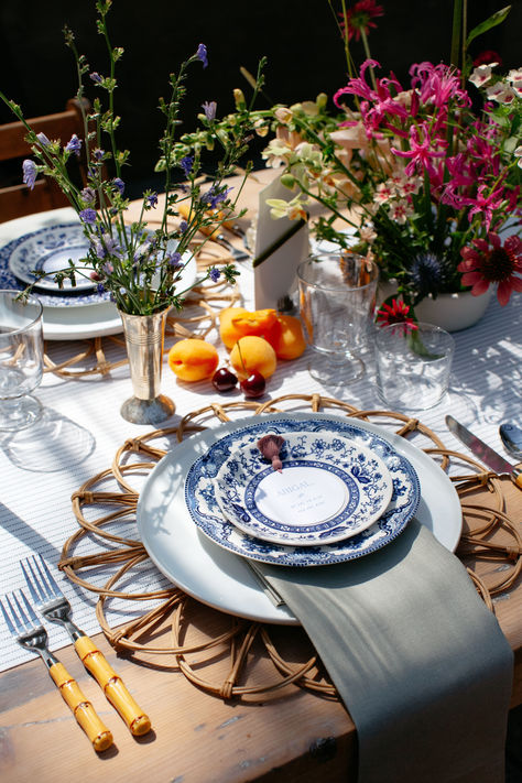 Blue and white vintage china plates are the star of this place setting accented with a wicker flower charger and bamboo flatware. The sage green napkin and white plate bring a modern element to this high detail place setting. Mexican Inspired Table Setting, Spanish Elopement, Anastasia Wedding, Outdoor Garden Party, Bamboo Flatware, Rattan Charger, Glass Charger Plates, Photography Trends, White Dinner