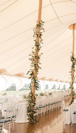 Tent Poles w/ Ivy and floral Decorating Poles For Wedding, Greenery On Tent Poles, Wedding Pole Decorations, Pole Tent Decorations, Flower Poles Wedding, Pole Decorations Ideas Wedding, Wedding Tent Pole Decorations, Tent Flower Decorations, Wedding Tent Flowers