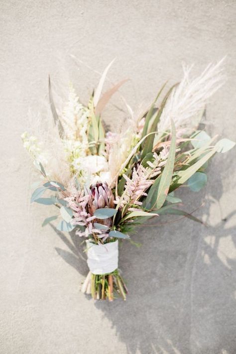 Florist Kelly Lenard of Intertwine proved that rustic and beach wedding styles can absolutely mix with this eucalyptus, astilbe, aloe vera leaves, artichoke, lavender, and pampas grass bouquet. Astilbe Bouquet, Beach Bouquet, Beach Wedding Style, Rustic Beach Wedding, Beach Wedding Decorations Reception, Beach Wedding Centerpieces, Peony Bouquet Wedding, Beach Wedding Flowers, Rustic Bouquet