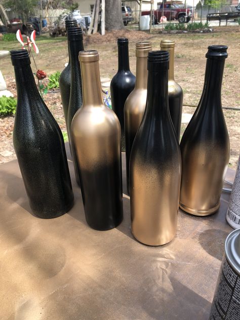 Black And Gold Bottles Diy, Black And Gold Rustic Decor, Wine Bottle Centerpieces For Birthday, Black Wine Bottle Decor, Black And Gold Vase Centerpieces, Diy Wine Bottle Centerpieces, Black And Gold Wine Bottle Centerpieces, Black Gold Burgundy Wedding Centerpieces, Black Gold And Silver Centerpieces