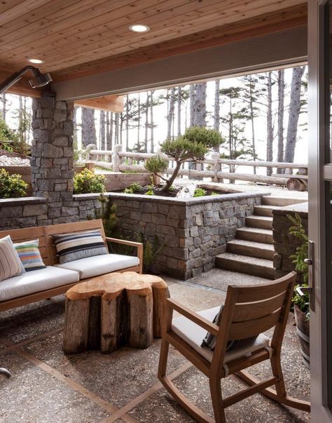 This porch is perfect for lazy summer days. The exterior of this home is clad in naturally grey timbers and stone, so the house almost blends into the seascape. #porchideas #outdoorstyling #housestyling Walkout Basement Patio, Patio Under Decks, Sunken Patio, Stone Wall Design, Small Basements, House With Porch, Up House, Exterior Stone, Basement Decor