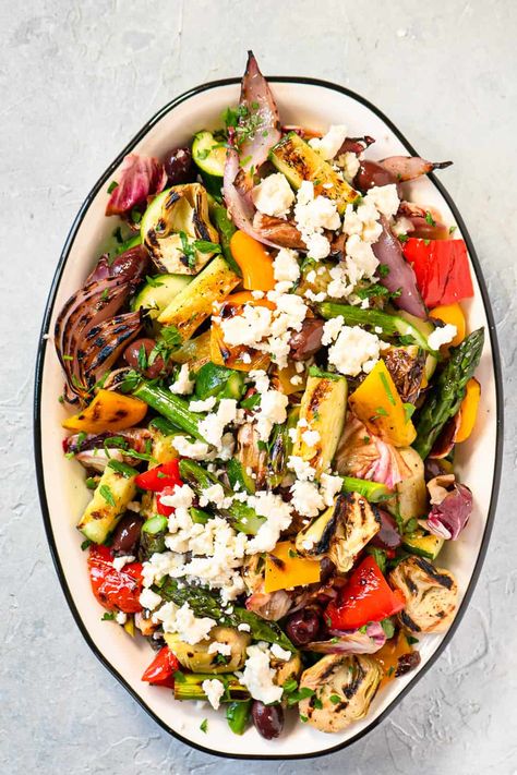 This Grilled Vegetable Salad Recipe is the absolute BEST! Kalamata olives, artichokes, and feta cheese add a Mediterranean flair. Dressing the salad while it's still warm with Lemon Garlic Vinaigrette just rounds everything out perfectly. This recipe is quick and easy, perfect for a crowd or for epic leftovers! Grilled Summer Vegetable Salad, Quinoa Grilled Vegetable Salad, Grilled Vegetable Salad Recipes, Grilled Artichoke Salad, Mediterranean Vegetable Salad, Warm Veggie Salad, Cooked Vegetable Salad, Grilled Mediterranean Recipes, Gina Livy Recipes