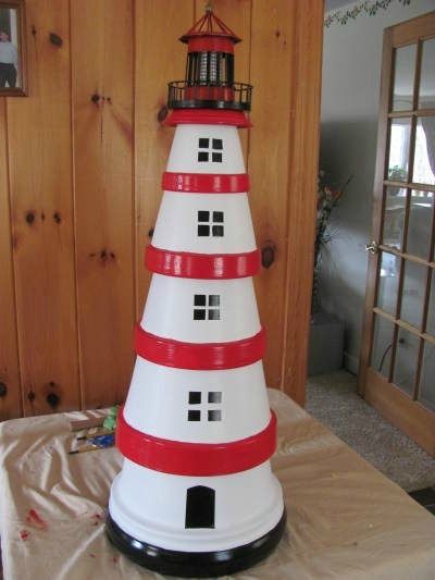 This is a guide about making a terra cotta lighthouse. An inexpensive craft project made with clay pots is a lighthouse for a garden decoration. How To Make A Lighthouse From Clay Pots, Plant Pot Lighthouse, Light House Project For School, Lighthouse Diy How To Make, Clay Pot Lighthouse With Solar Light, Terracotta Lighthouse, Diy Lighthouse, Clay Pot Lighthouse, Lighthouse Crafts